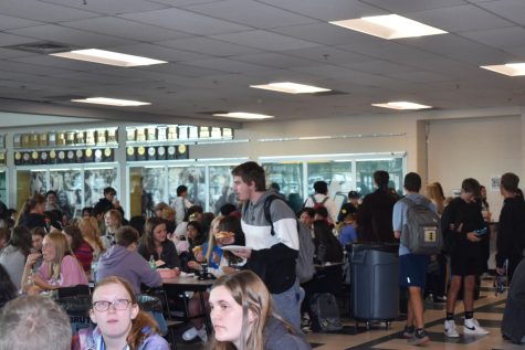 Jacob Kauer (10) navigates the crowded lunch room during the first all-school lunch. It can be a bit crowded, but its ok. said Kauer, who recently moved from Arizona. 