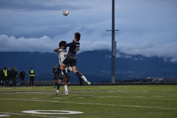 Lincoln Valentine (11) heads the ball during the recent game against Cherokee Trail. Despite the teams best efforts, they came up short losing 2-0. 