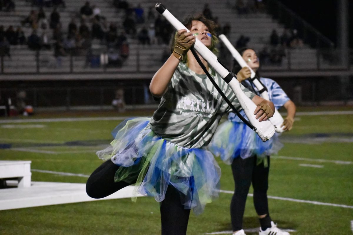 Eris Sindler (12) shows off her rifle work at the band's debut performance on September 20 at the homecoming half time show. Photo by Hannah Scalise