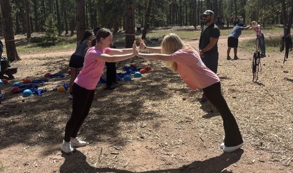 Bethany Mertens (12) and Skylar Fortney (11) participate in trust-building exercises at the High Trails Leadership camp on August 28 in Florissant, CO. Photo Courtesy of Promis Hoffman