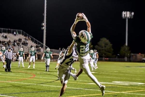 Connor Stallman (12) catches a pass at the first home game of the season against Arapahoe on September 20. The Eagles outscored the Warriors 34-13. 