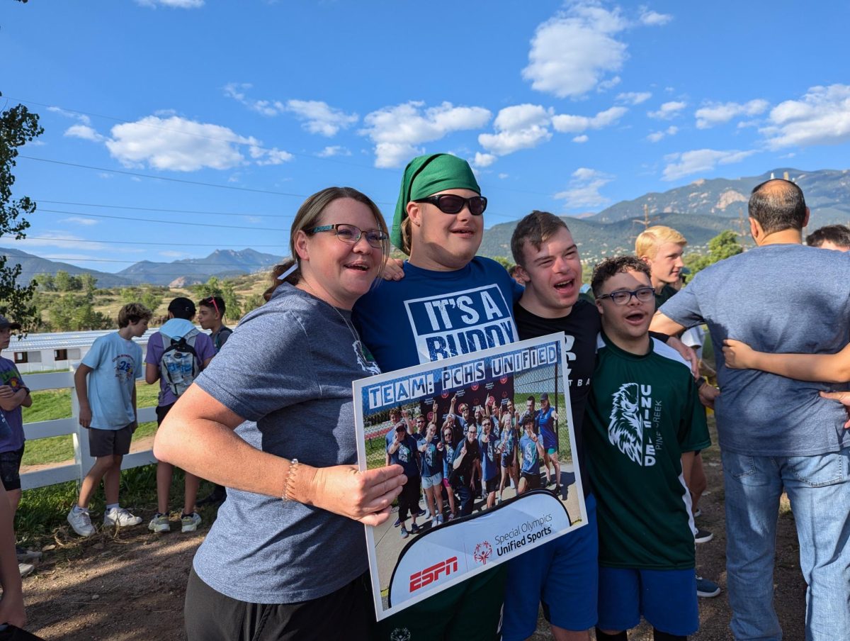 Heather Pinder poses with Evan Moore, Joshua Tobiasz and Jaemen Morales at the Down syndrome walk. Moore, Tobiasz and Morales have been active participants in Unified Sports at Pine Creek.