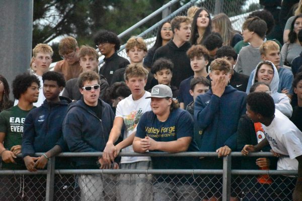The student section cheers on their respective teams.