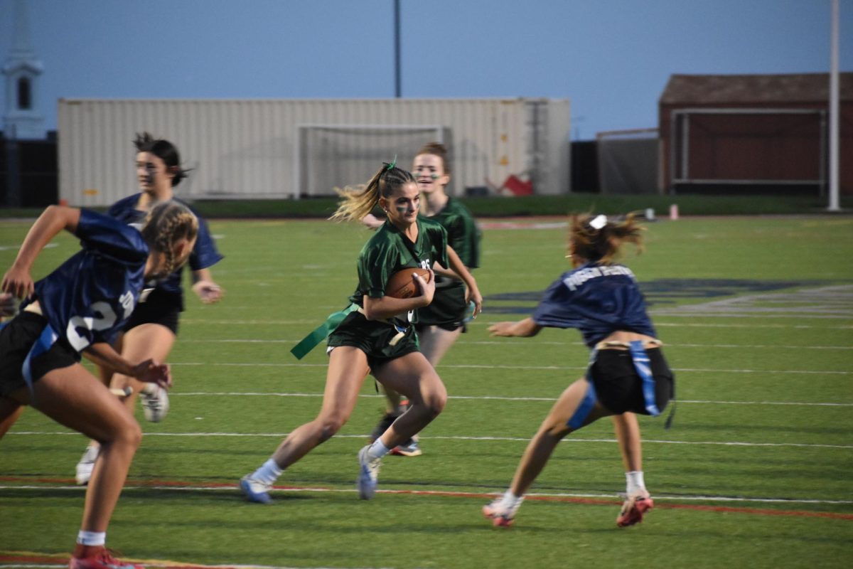 The senior running back evades the Junior defense in heated play. (1st Quarter)